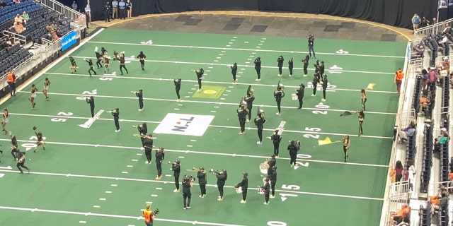 The SOS marching band forms a heart on the field during one of their performances.