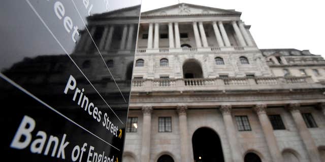 The Bank of England building is reflected in a sign, London, Britain, on Dec. 16, 2021.