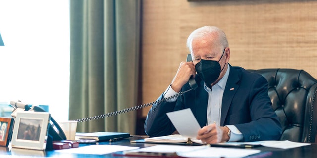 President Biden wears a mask while working in the West Wing Friday after testing positive for COVID-19. 