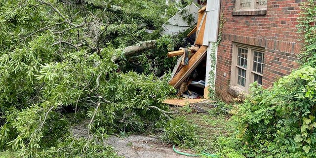 A tree fell on a home in Birmingham, Alabama, during a severe storm, killing two children.