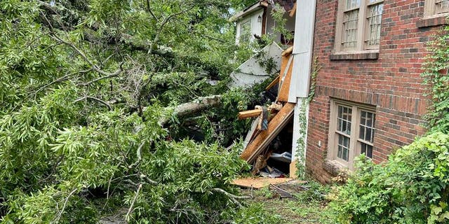 A tree fell on a home in Birmingham, Alabama, during a severe storm, killing two children.