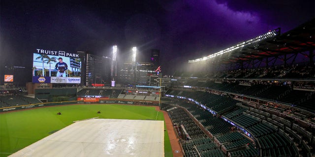 Play is stopped for a weather delay in the fifth inning of a baseball game between the Atlanta Braves and the St. Louis Cardinals, Monday, July 4, 2022, in Atlanta. 