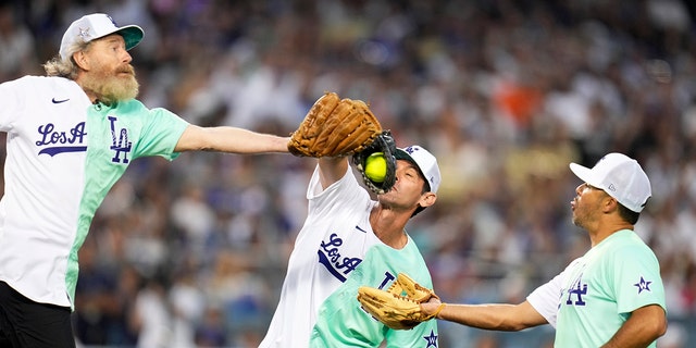 Shawn Green catches a fly ball in between Bryan Cranston, left, and Andre Either in the first inning of the All-Star Celebrity Softball Game at Dodger Stadium in Los Angeles on Saturday, July 16, 2022. (Photo by Keith Birmingham/MediaNews Group/Pasadena Star-News via Getty Images)