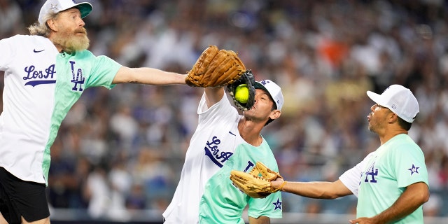 Shawn Green catches a fly ball in between Bryan Cranston, left, and Andre Either in the first inning of the All-Star Celebrity Softball Game at Dodger Stadium in Los Angeles on Saturday, July 16, 2022. (Photo by Keith Birmingham/MediaNews Group/Pasadena Star-News via Getty Images)