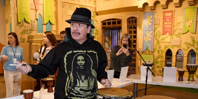 Recording artist Carlos Santana autographs congas that he and his wife Cindy Blackman Santana donated to the Las Vegas Philharmonic while participating in the Philharmonic's global edition of the orKIDStra music education program for a group of students at the Discovery Children's Museum on October 29, 2019 in Las Vegas, Nevada.  (Photo by Ethan Miller/Getty Images)