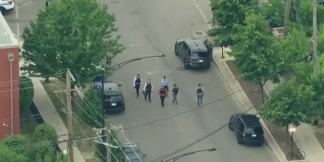 Aerial shots show police officers gathering at the scene where a Chicago police officer was shot Friday morning.