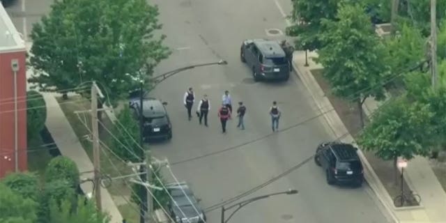 Aerial shots show police officers gathering at the scene where a Chicago police officer was shot Friday morning.