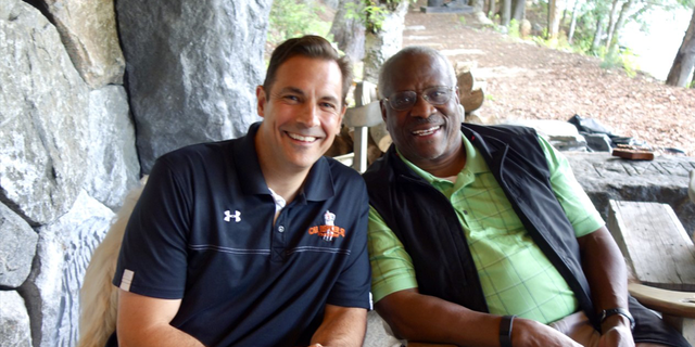 An image of Justice Clarence Thomas and author/attorney Mark Paoletta.