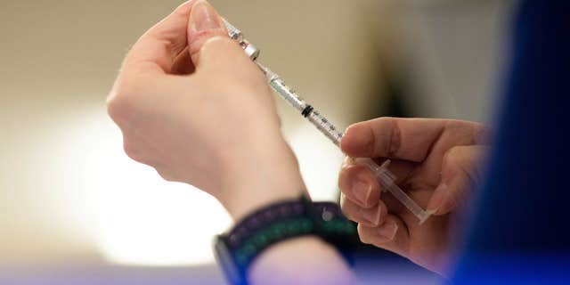 Nurse prepares COVID-19 Vaccines in Waterford, Michigan, in April 2022.