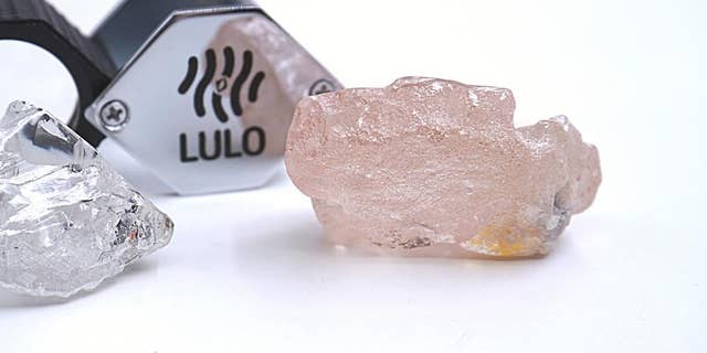 This photo supplied by Lucapa Diamond Company on Wednesday, July 27, 2022, shows the 170-carat pink diamond, right, recovered from Lulo, Angola. 