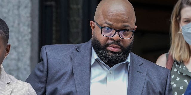 R. Kelly's manager Donnell Russell, second from left, leaves federal court, Wednesday, July 20, 2022, in New York. A jury convicted Russell on Friday, July 22, of threatening gunfire was about to occur at a crowded Manhattan theater preparing to show a documentary about the singer's sexual abuse of women and girls.
