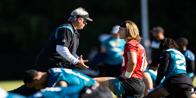 Head Coach Doug Pederson of the Jacksonville Jaguars speaks with Trevor Lawrence #16 during training camp at Episcopal High School on July 25, 2022 in Jacksonville, Florida.