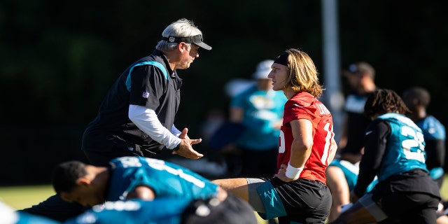 Head coach Doug Pederson of the Jacksonville Jaguars talks to Trevor Lawrence #16 during Training camp at Episcopal High School on July 25, 2022 in Jacksonville, Florida.