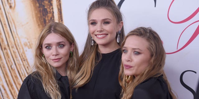 Elizabeth Olsen with twin sisters Mary Kate and Ashley Olsen.