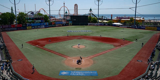 Infielders array in a traditional pattern as rules changes to restrict shifts are observed during a minor league baseball game between the Brooklyn Cyclones and Greensboro Grasshoppers, Wednesday, July 13, 2022, in the Coney Island neighborhood of the Brooklyn borough of New York. Major League Baseball is considering a pitch clock for next year along with shift limits, larger bases and restrictions on pickoff attempts.  