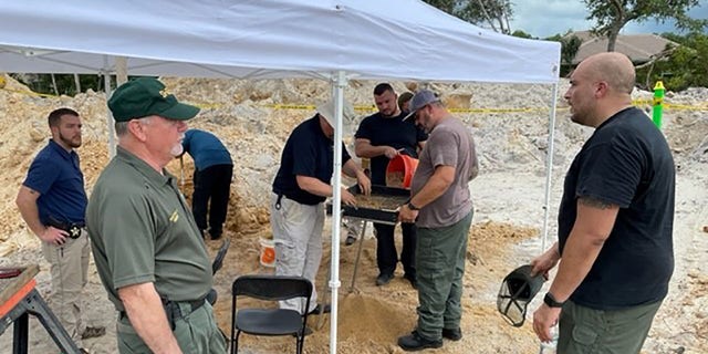 Investigators with the sheriff's office and Florida Department of Law Enforcement search the scene in Palm City, Florida, on July 19.