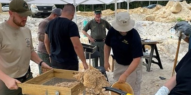 Investigators searched the dirt piles at the site in Palm City, Florida, on July 19 for further signs of human remains.