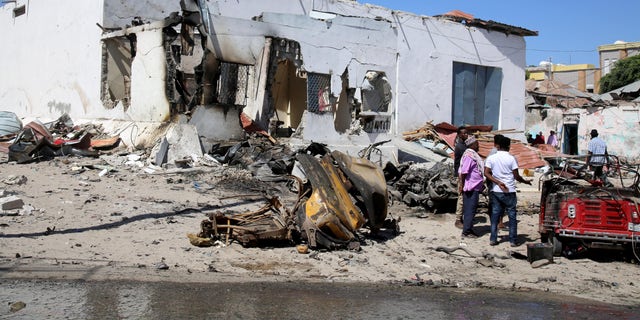 Damage at the scene after the explosion of a suicide vehicle targeting security forces in Mogadishu, Somalia, January 12, 2022. 