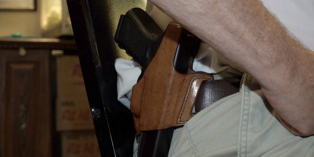 Dave Giles sports a pistol during his interview with Fox News.