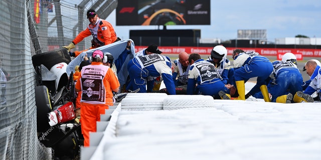Zhou's car became stuck between the safety barrier and the catch fence.