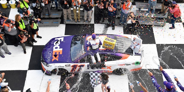 Denny Hamlin celebrated his Pocono win before his car was disqualified.