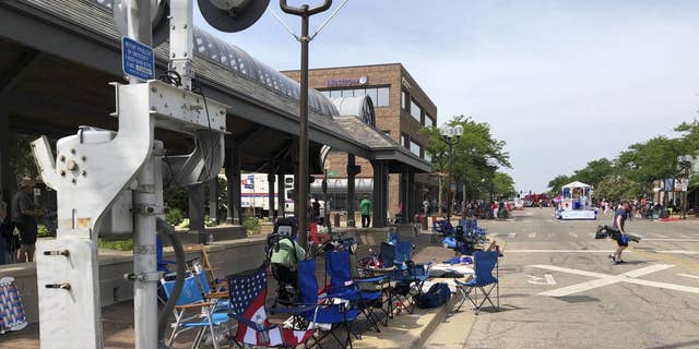 Empty chairs sit along the sidewalk after parade-goers fled Highland Park's Fourth of July parade after shots were fired, Monday. 