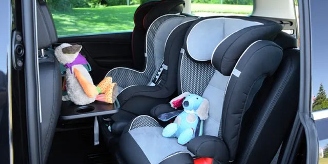 FILE - Seats for children mounted in a minivan. A 1-year-old North Carolina girl died July 1, 2022 after being left in a hot vehicle.