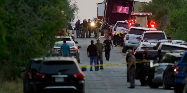 Police and other first responders work the scene where officials say dozens of people were found dead and others hospitalized with heat-related illnesses after a tractor-trailer containing illegal migrants was found on June 27, 2022, in San Antonio.