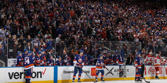 Fans celebrate a first-period goal by Brock Nelson (29) of the New York Islanders, the first in the new building, against the Calgary Flames at the UBS Arena Nov. 20, 2021, in Elmont, N.Y.