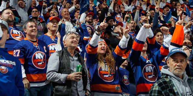 Fans celebrate a first-period goal by Brock Nelson of the New York Islanders, the first goal scored at UBS Arena Nov. 20, 2021, in Elmont, N.Y.