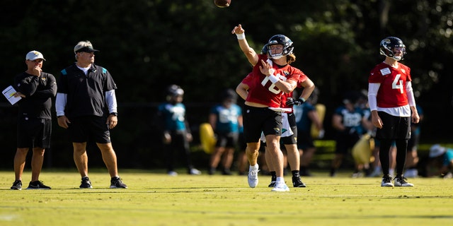 No. 16 Trevor Lawrence of the Jacksonville Jaguars throws a pass during training camp on July 25, 2022 at Episcopal High School in Jacksonville, Florida.