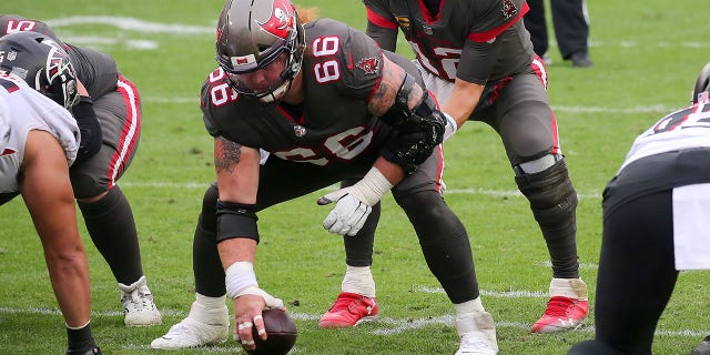 Tom Brady of the Tampa Bay Buccaneers under center Ryan Jensen during a regular season game between the Atlanta Falcons and the Buccaneers at Raymond James Stadium in Tampa, Florida on January 3, 2021.