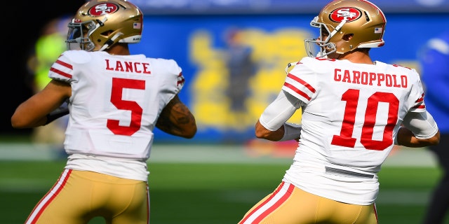San Francisco 49ers Quarterback Trey Lance, #5, and San Francisco 49ers Quarterback Jimmy Garoppolo, #10, warm up before the NFL game between the San Francisco 49ers and the Los Angeles Rams on January 9, 2022, at SoFi Stadium in Inglewood, CA