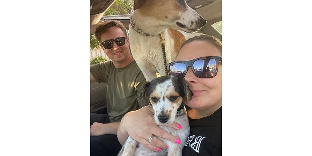 U.S. Navy Chief Petty Officer Matt Johnson (left) and Navy veteran Coreen Johnson snap a selfie with their two dogs, Ruby and Sunny. "The dogs are our family," said CPO Johnson. 