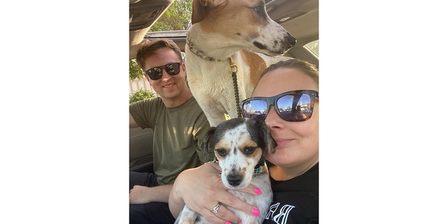 U.S. Navy Chief Petty Officer Matt Johnson and Navy veteran Coreen Johnson snap a selfie with their two dogs, Ruby and Sunny. "The dogs are our family," said CPO Johnson.