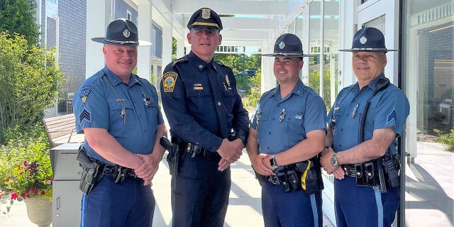 Newly-sworn-in Oak Bluffs police chief Jonathan Searle stands with Massachusetts state police officers.