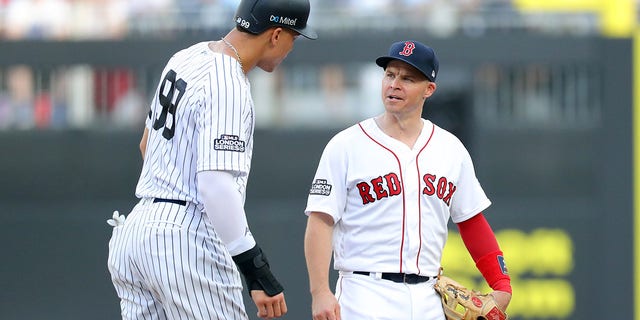 Aaron Judge, #99 of the New York Yankees, and Andrew Benintendi, #16 of the Boston Red Sox, are seen talking during game one of the London Series between the New York Yankees and the Boston Red Sox at London Stadium on Saturday, June 29, 2019 in London, England. 