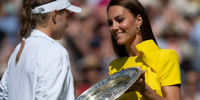 The Duchess of Cambridge presents the Venue Rosewater dish to Elena Rybakina, who won her match against Ons Jabeur during the women's singles final at Wimbledon on July 9, 2022, in London.