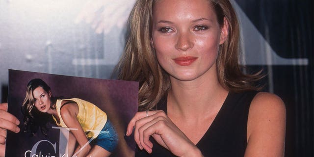 Kate Moss holding an ad for Calvin Klein Jeans that she appears in at Robinson's at the Santa Monica Mall, Santa Monica, California, April 19, 1997.