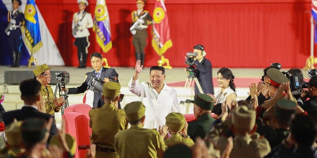 Kim Jong Un waves to Korean War veterans on July 27, 2022. 