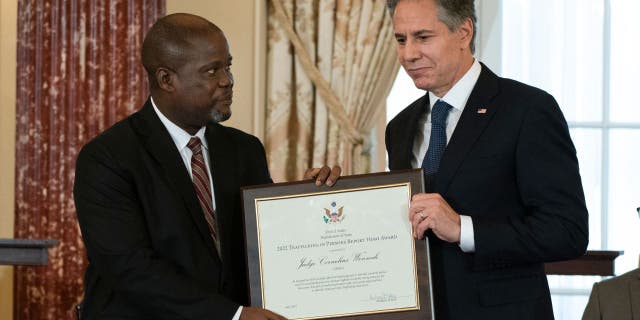 US Secretary of State Antony Blinken presents the 2022 Trafficking in Persons Hero Award to Judge Cornelius Wennah, of Liberia, during the 2022 Trafficking in Persons (TIP) Report launch ceremony