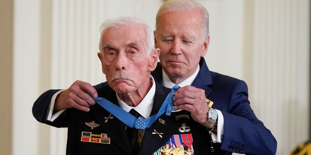 President Joe Biden awards the Medal of Honor to retired Maj. John Duffy for his actions on April 14-15 1972, during the Vietnam War, during a ceremony in the East Room of the White House, Tuesday, July 5, 2022, in Washington. (AP Photo/Evan Vucci)