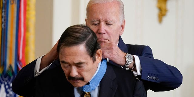 President Joe Biden awards the Medal of Honor to Spc. Dennis Fujii for his actions on Feb. 18-22 1971, during the Vietnam War, during a ceremony in the East Room of the White House, Tuesday, July 5, 2022, in Washington. (AP Photo/Evan Vucci)