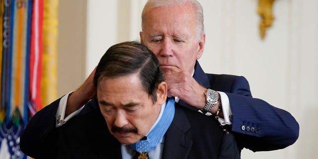 President Joe Biden awards the Medal of Honor to Spc. Dennis Fujii for his actions on Feb. 18-22 1971, during the Vietnam War, during a ceremony in the East Room of the White House, Tuesday, July 5, 2022, in Washington. (AP Photo/Evan Vucci)