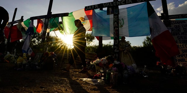 Mourners visit a make-shift memorial to honor the victims and survivors of the June human smuggling tragedy on July 6, 2022, in San Antonio. 