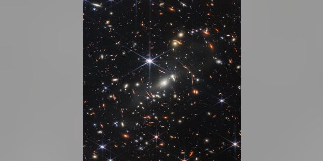 This image from the James Webb Space Telescope shows galaxies around each other with light that has been bent, NASA officials said.