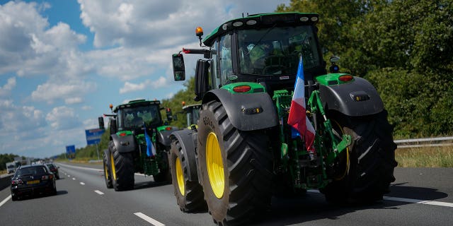 Demonstrating farmers slow down traffic on a motorway near Venlo, Netherlands, Monday, July 4, 2022. Dutch farmers angry at government plans to slash emissions used tractors and trucks Monday to blockade supermarket distribution centers, the latest actions in a summer of discontent in the country's lucrative agricultural sector. 