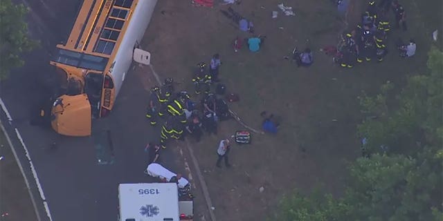 Firefighters at the scene of an overturned school bus in the Bronx, New York.