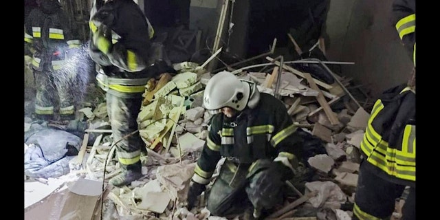 In this photo provided by the Ukrainian Emergency Service, first responders work a damaged residential building in Odesa, Ukraine, early Friday, July 1, 2022, following Russian missile attacks. Ukrainian authorities said Russian missile attacks on residential buildings in the port city of Odesa have killed more than a dozen people.