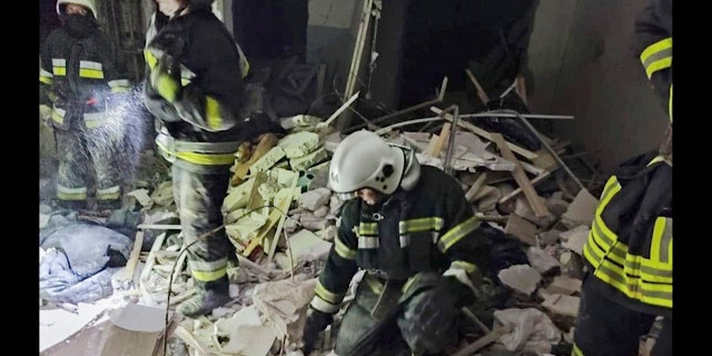 In this photo provided by the Ukrainian Emergency Service, first responders work a damaged residential building in Odesa, Ukraine, early Friday, July 1, 2022, following Russian missile attacks. Ukrainian authorities said Russian missile attacks on residential buildings in the port city of Odesa have killed more than a dozen people.